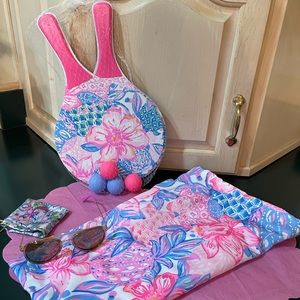 Lilly Pulitzer has you ready for fun. A paddle tennis game and some sun glasses.